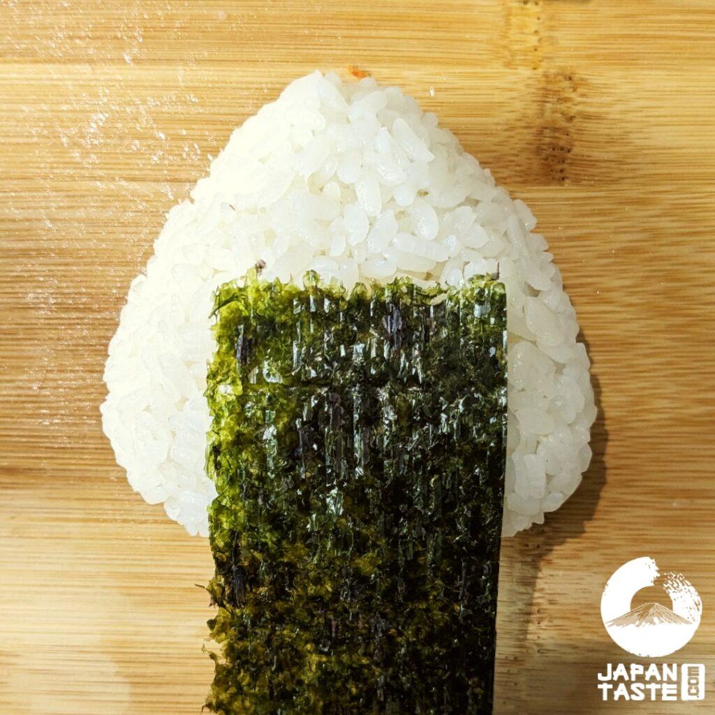 Wrap a small strip of nori, less wide than the onigiri