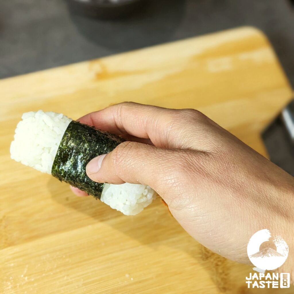 Wrap the nori completely around the onigiri